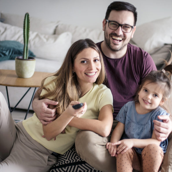 What is new? Family at home watching TV.