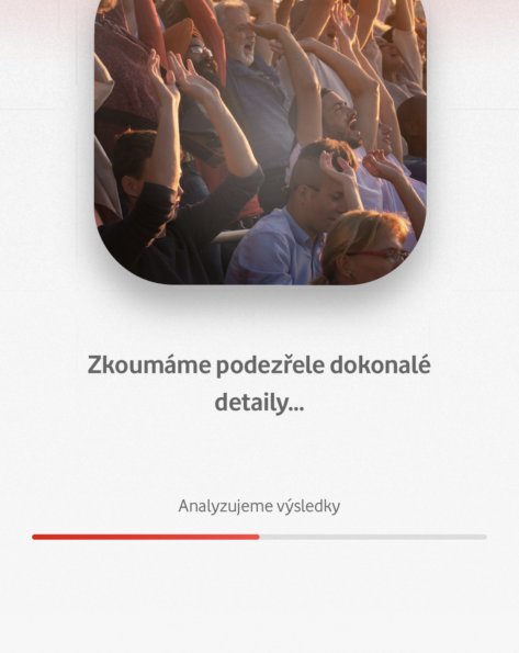 Aplikace analyzuje fotografii davu lidí se zdviženýma rukama.